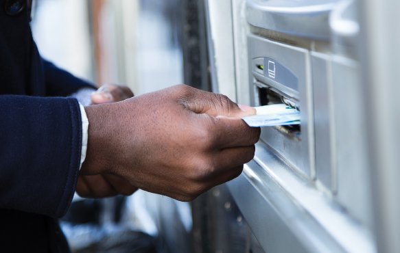 Man using card at ATM machine